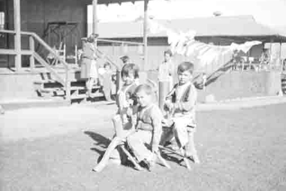 Black and white image of children playing outdoors in Manzanar